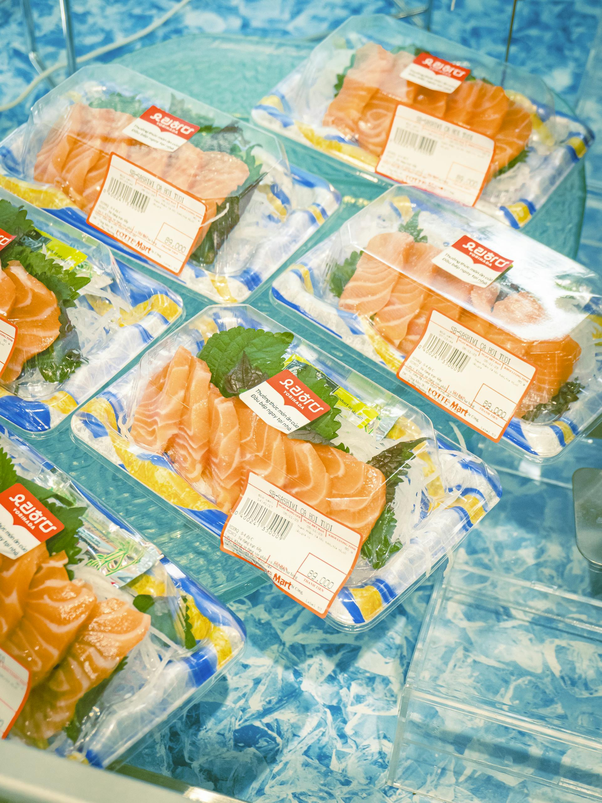 High-angle view of packaged salmon fillets in a refrigerated grocery store section.