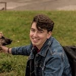 Young man enjoying a day at the park with his dog. Perfect outdoor lifestyle scene.