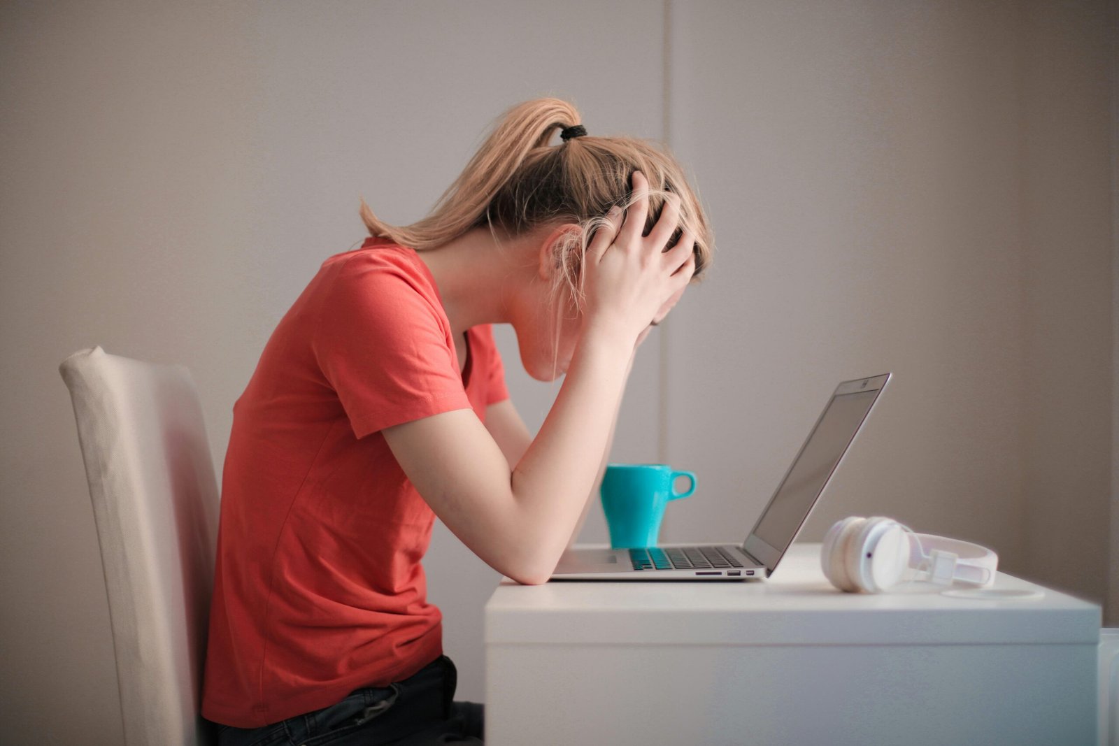 stressed woman working on laptop showing mental overload affecting sleep quality