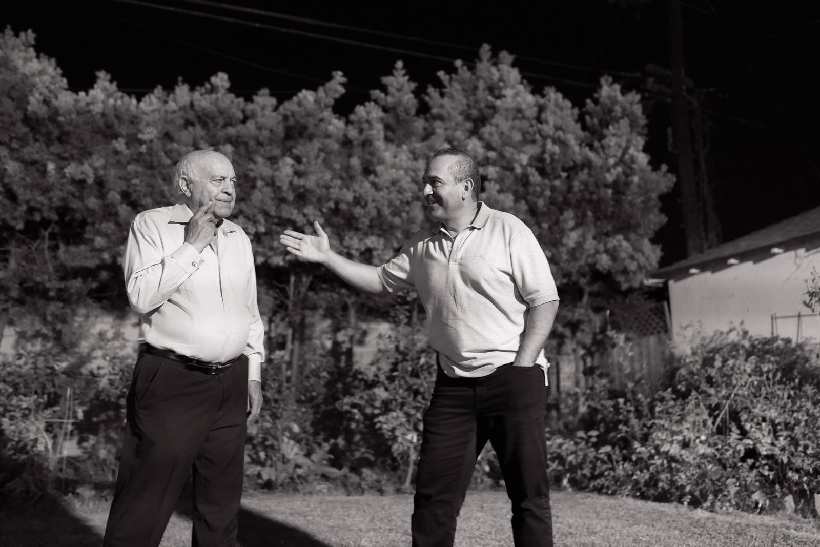 Older father and adult son talking outdoors, a reminder that heart risk runs in families