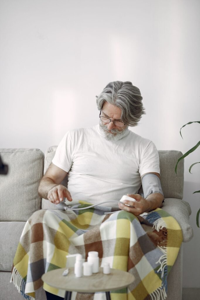 Heart health after 40: a man in his 50s checking his blood pressure at home