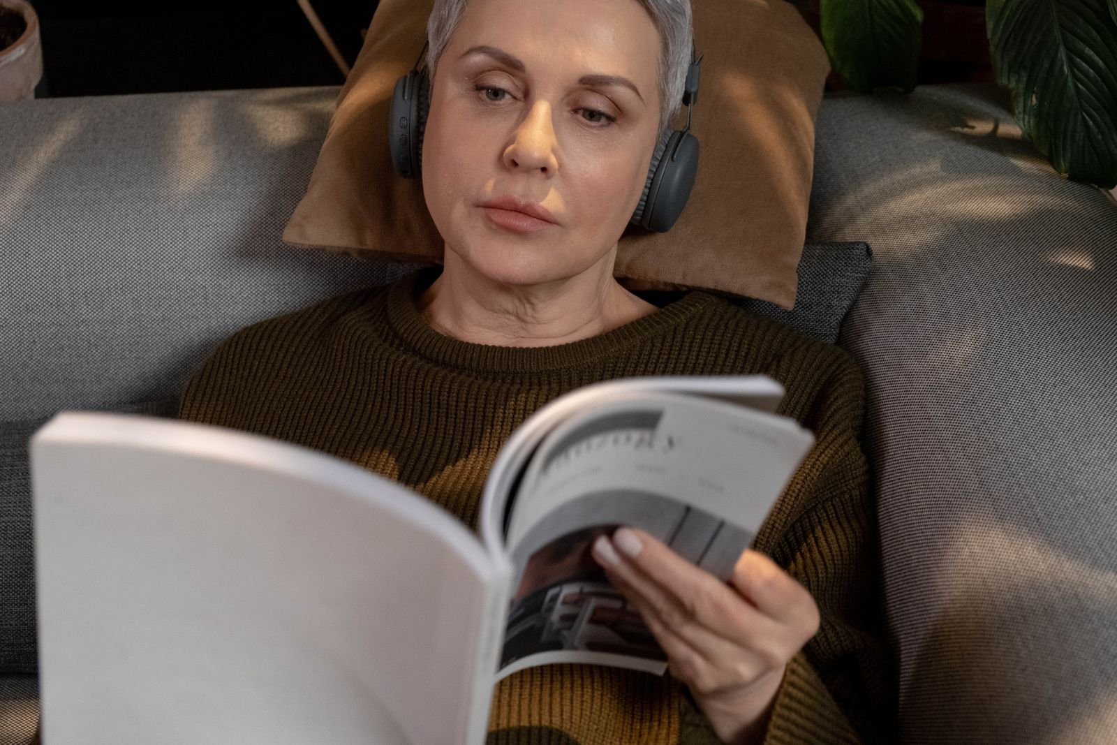 Woman relaxing with a magazine on the couch