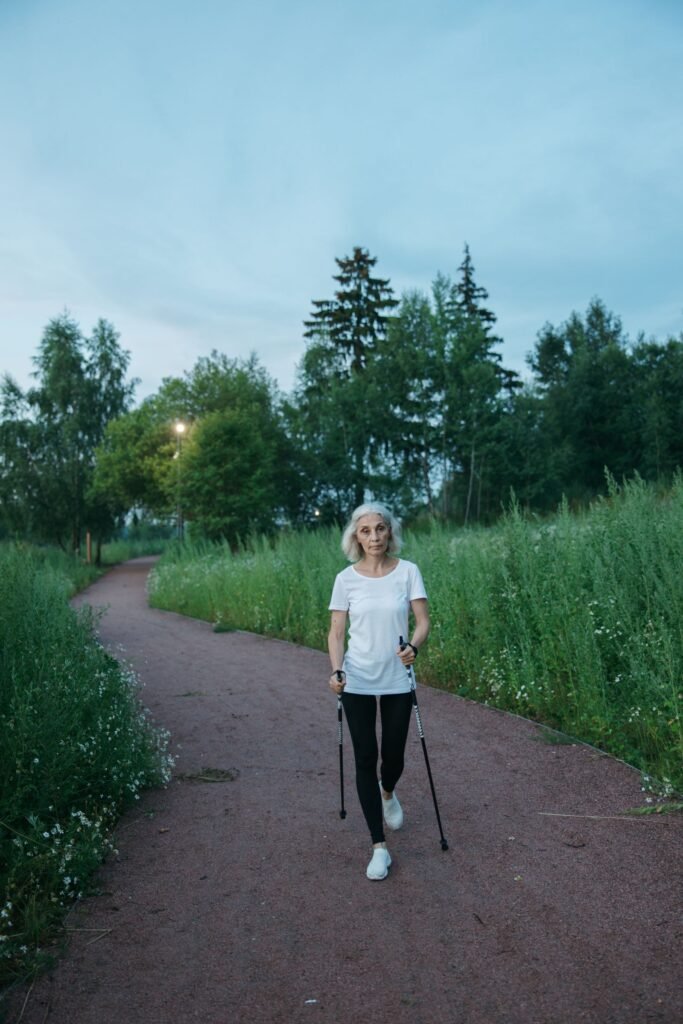 Woman over 50 walking in a park after a meal, a simple habit that helps lower A1C levels